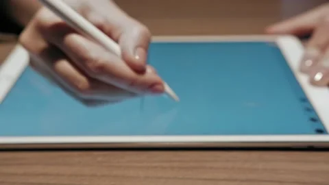 Hand using stylus pen on mini digital tablet on white table background Stock Footage 231015395