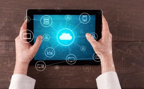 Hand using tablet with centralized cloud computing system concept 写真素材