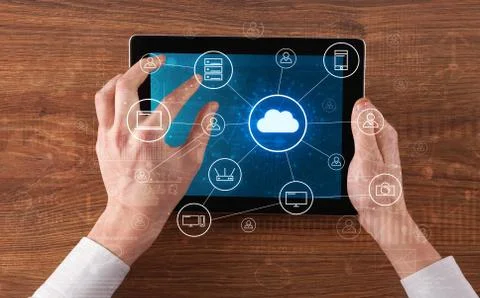 Hand using tablet with centralized cloud computing system concept Stock Photos