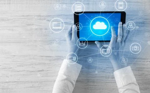 Hand using tablet with centralized cloud computing system concept Stock Photos