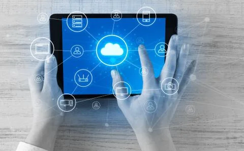 Hand using tablet with centralized cloud computing system concept 写真素材