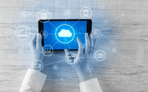Hand using tablet with centralized cloud computing system concept 写真素材