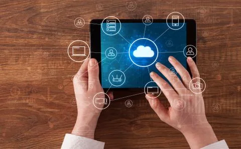 Hand using tablet with centralized cloud computing system concept Stock Photos