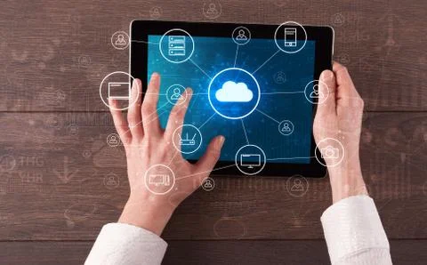 Hand using tablet with centralized cloud computing system concept Stock Photos