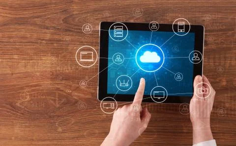Hand using tablet with centralized cloud computing system concept Stock Photos