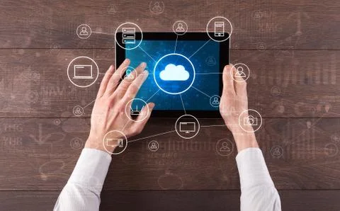 Hand using tablet with centralized cloud computing system concept 写真素材