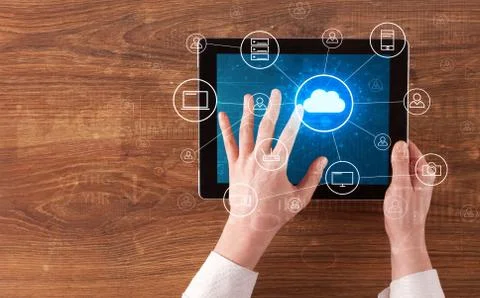Hand using tablet with centralized cloud computing system concept 写真素材