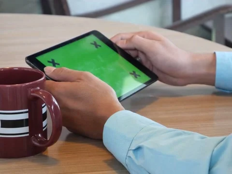 Hand using tablet computer pc commuters in background Stock Footage 63182253