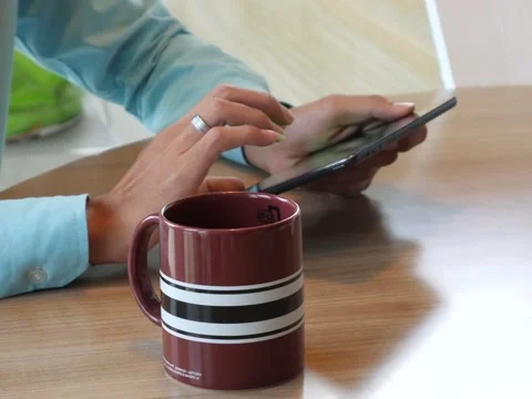 Hand using tablet computer pc commuters in background Stockbeeldmateriaal 63182257