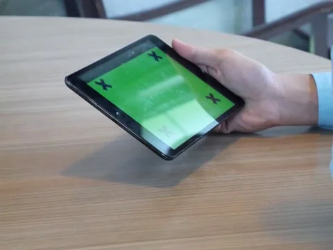 Hand using tablet computer pc commuters in background Stock Footage 63182265