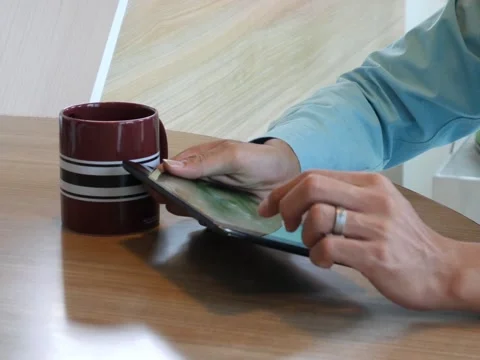 Hand using tablet computer pc commuters in background Stock Footage 63182267