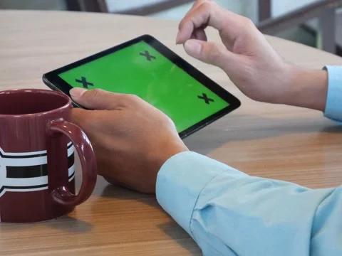 Hand using tablet computer pc commuters in background Stockbeeldmateriaal 63182289