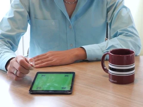 Hand using tablet computer pc commuters in background Stockbeeldmateriaal 63182493