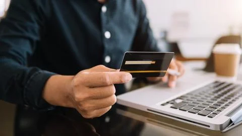 Hand using tablet ,laptop, and holding mobile with credit card online banki.. Stock Photos