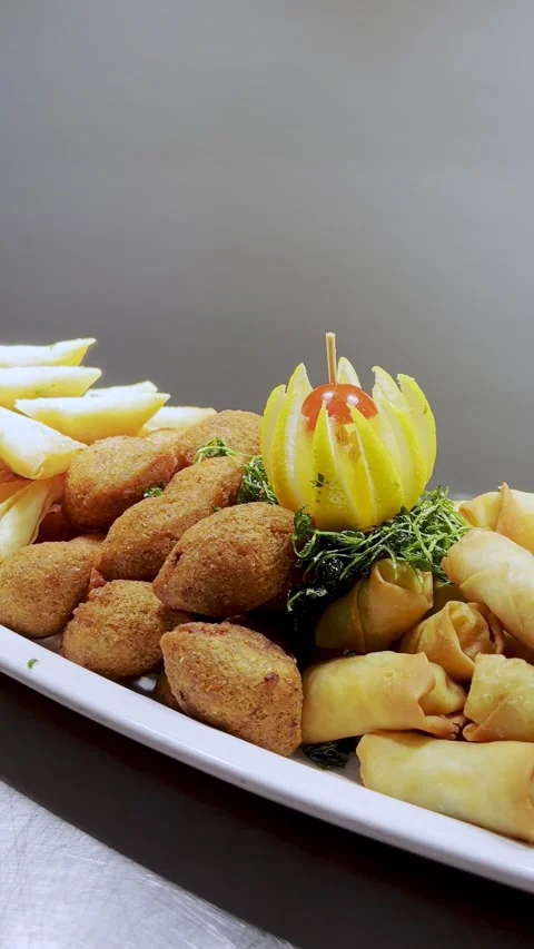 Hand Using Tongs Serving Fried Appetizers Stock Footage 341716932