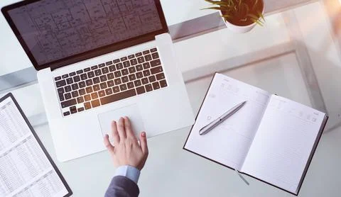 Hand using touchpad on laptop at home Stock Photos