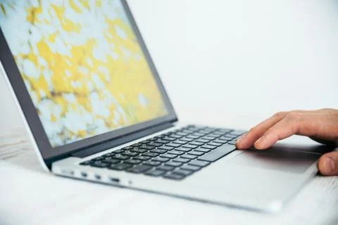 Hand using touchpad on laptop Stock Photos