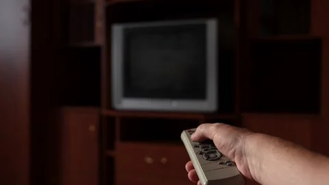 Hand using TV remote, searching channel on old television Stock Footage 314634171