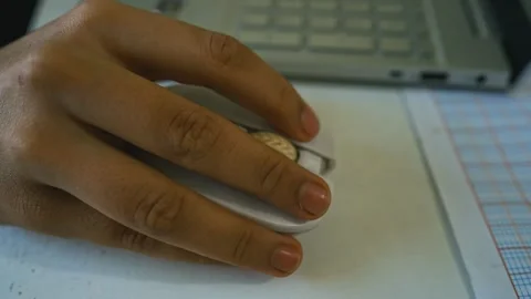 Hand Using White Computer Mouse on Desk, Close-up of a hand using a white c.. Stock Footage 304977681