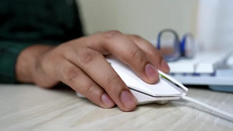 Hand Using White Computer Mouse on Desk, Close-up of a hand using a white c.. Stock Footage 317737136