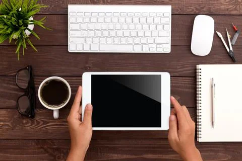 Hand using white tablet on workspace Stock Photos