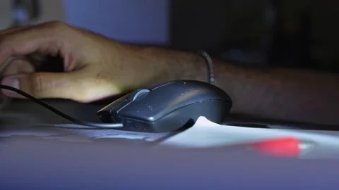 Hand Using Wired Computer Mouse on Desk in Low Light Stock Footage 333854278