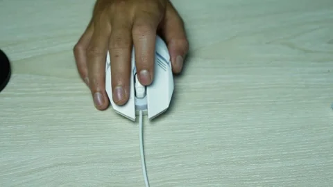 Hand Using a Wired Computer Mouse on Wooden Desk, Close-up of a hand using .. Video stock 345119647