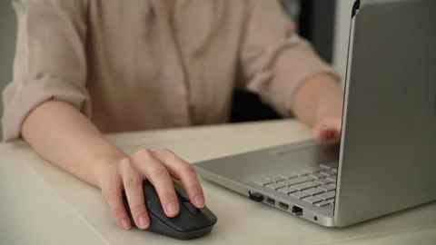 Hand Using Wireless Mouse Beside Laptop In Office Stock Footage 344574921