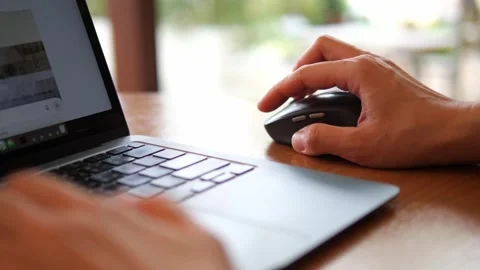 Hand Using Wireless Mouse While Working on Laptop Stock Footage 322007089