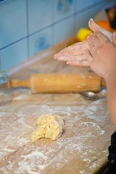 Hand using wooden rolling pin on kitchen counter photo 写真素材