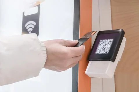 A hand is utilizing advanced contactless payment technology featuring a QR code Stock Photos