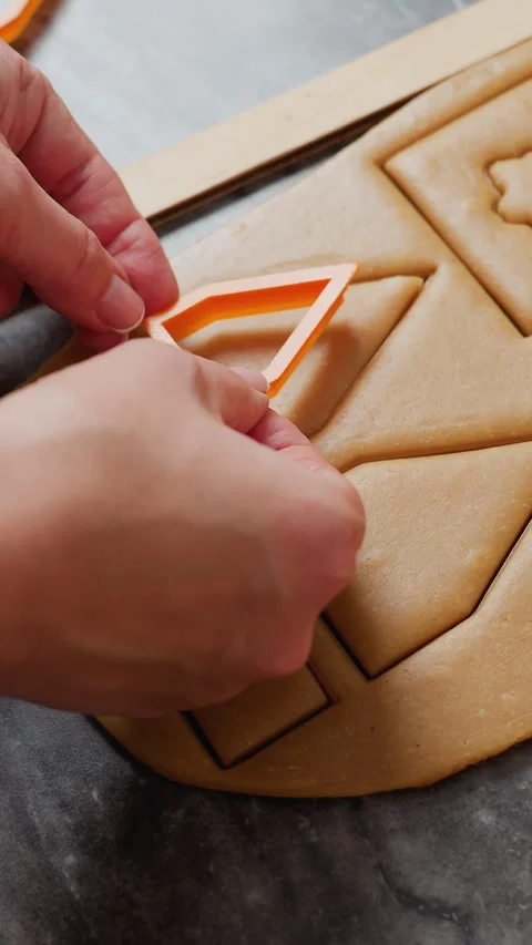 Hand View of Woman Using House-Shaped Cutter on Dough for Baking Stock Footage 320372368