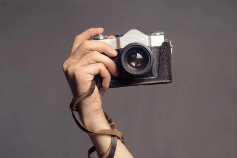 Hand with vintage camera Stock Photos