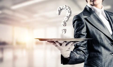 Hand of waiter presenting question mark on tray. Stock Photos