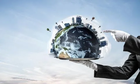 Hand of waitress presenting Earth globe on tray. Stock Photos
