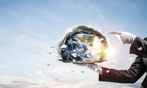 Hand of waitress presenting Earth globe on tray. Stock Photos