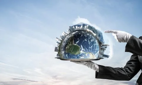 Hand of waitress presenting Earth globe on tray. Stock Photos
