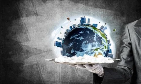 Hand of waitress presenting Earth globe on tray. Stock Photos