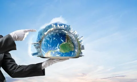 Hand of waitress presenting Earth globe on tray. Stock Photos