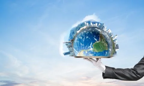 Hand of waitress presenting Earth globe on tray. Stock Photos