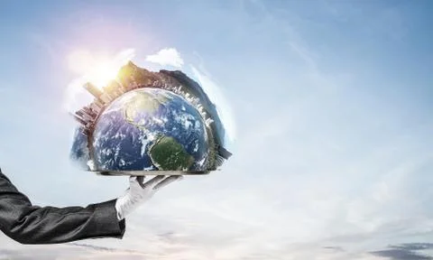 Hand of waitress presenting Earth globe on tray. Stock Photos