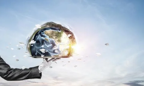 Hand of waitress presenting Earth globe on tray. Stock Photos
