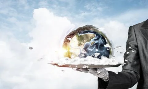 Hand of waitress presenting Earth globe on tray. Stock Photos
