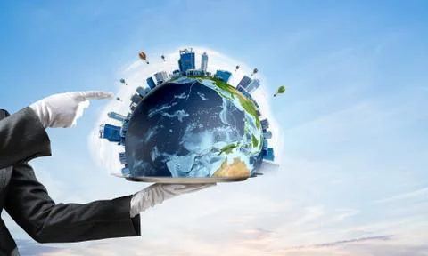 Hand of waitress presenting Earth globe on tray. Stock Photos