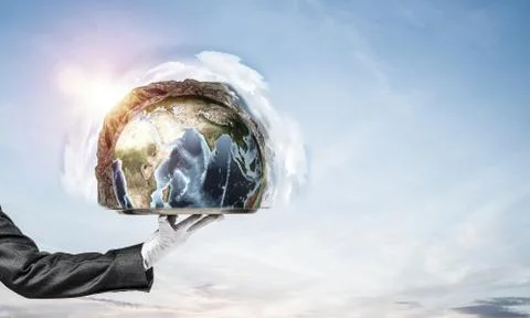 Hand of waitress presenting Earth globe on tray. Stock Photos