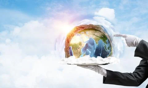 Hand of waitress presenting Earth globe on tray. Stock Photos