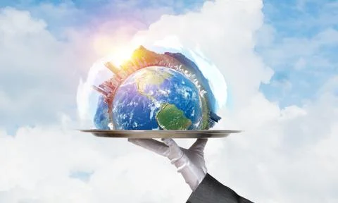 Hand of waitress presenting Earth globe on tray. Stock Photos