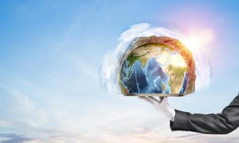 Hand of waitress presenting Earth globe on tray. Stock Photos