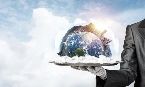 Hand of waitress presenting Earth globe on tray. Stock Photos