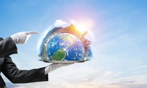Hand of waitress presenting Earth globe on tray. Stock Photos